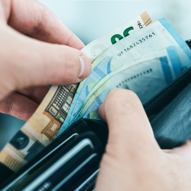 Hand with wallet and euro bills