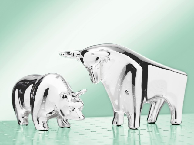 Metallic bull and bear posing with abstract background